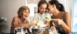 grandmother, mother, and daughter baking together